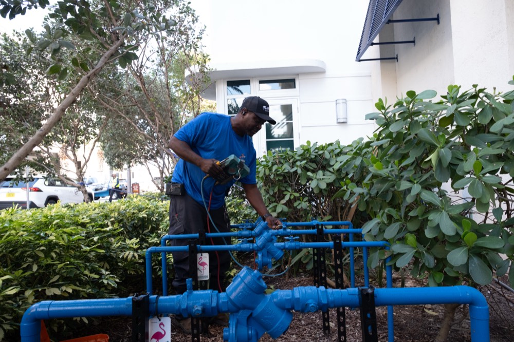 Technician working a full commercial backflow manifold installation