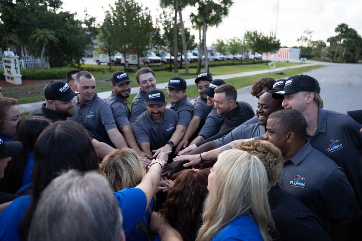 The Flamingo team putting their hands in together